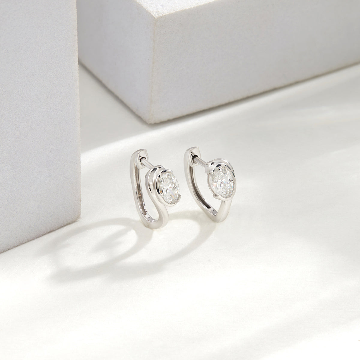 Lab Grown Diamond Oval Cut Bezel Set Huggie Hoop Earrings in Sterling Silver | 0.97 CT